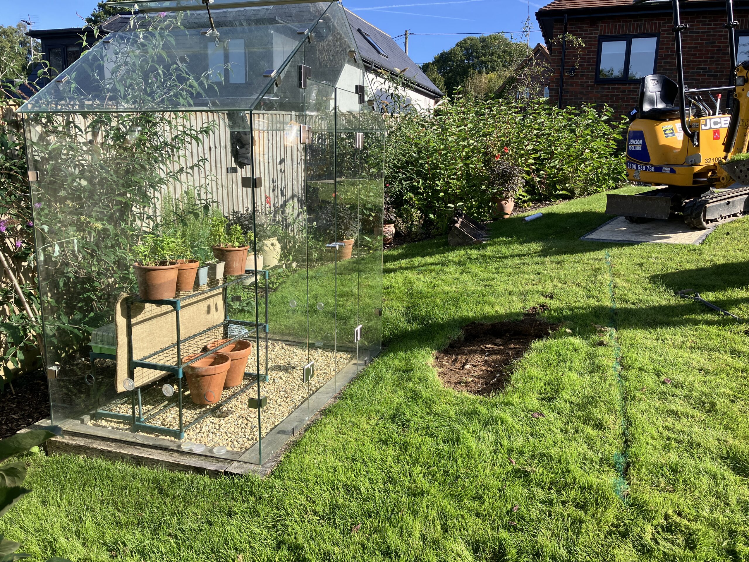 Greenhouse Landscaping – Before Garden bank before greenhouse landscaping and retaining wall construction