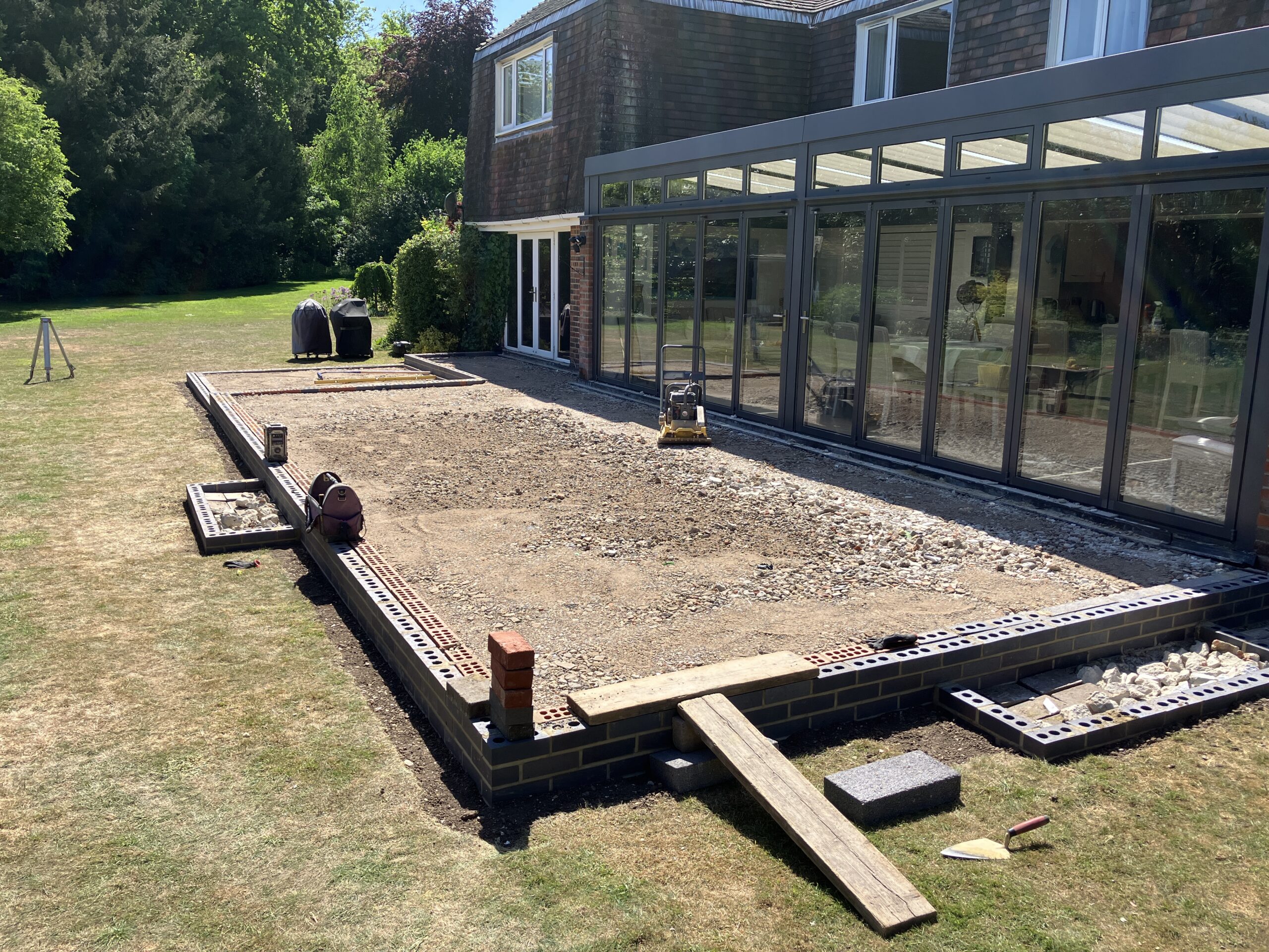 Porcelain Patio Installation Winchester. sub base Large porcelain patio with brick retaining walls in Winchester. sub base