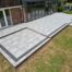 Large porcelain patio with brick retaining walls in Winchester
