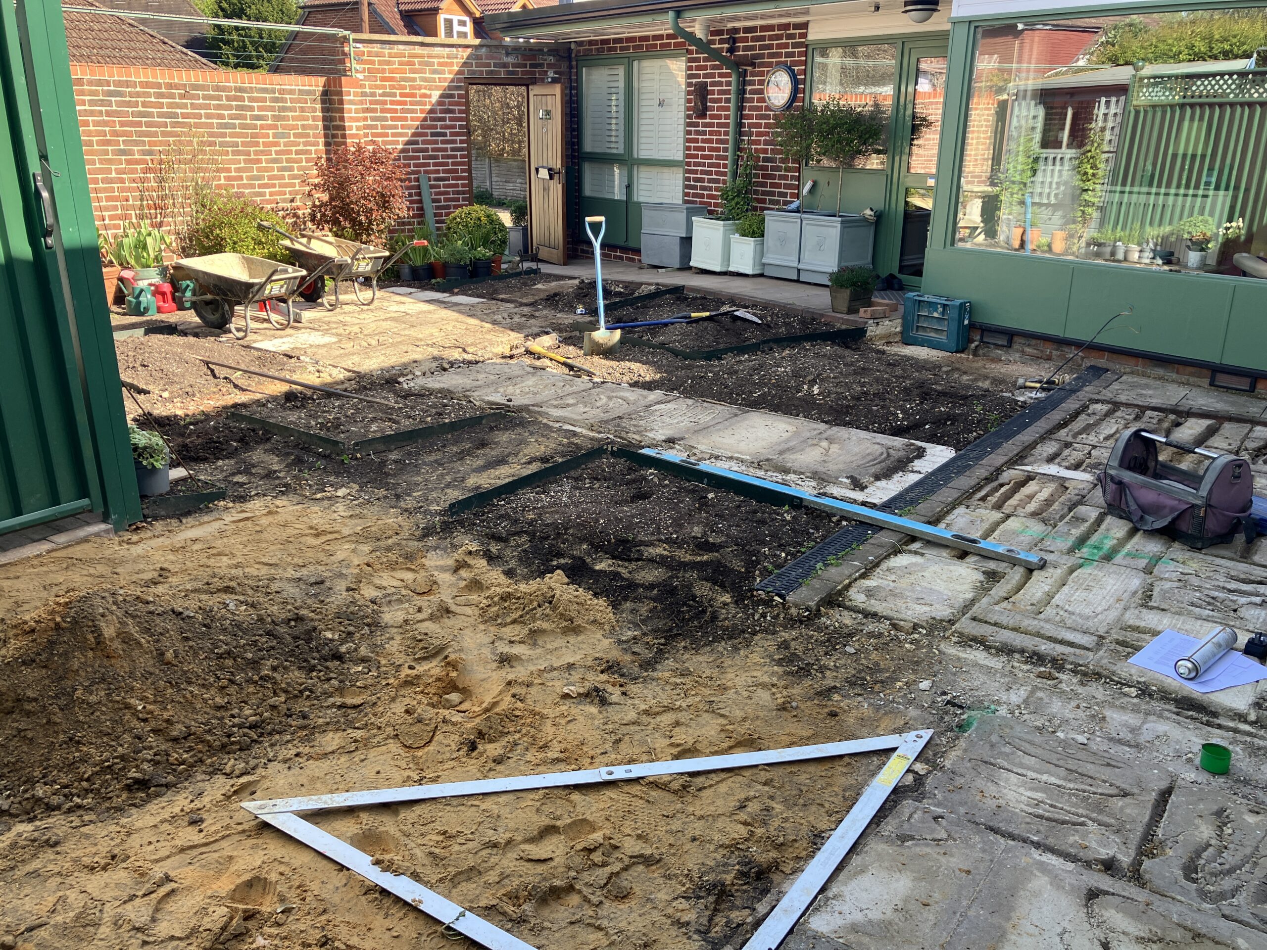 Construction of raised brick garden beds before porcelain paving installation Construction of raised brick garden beds before porcelain paving installation Winchester